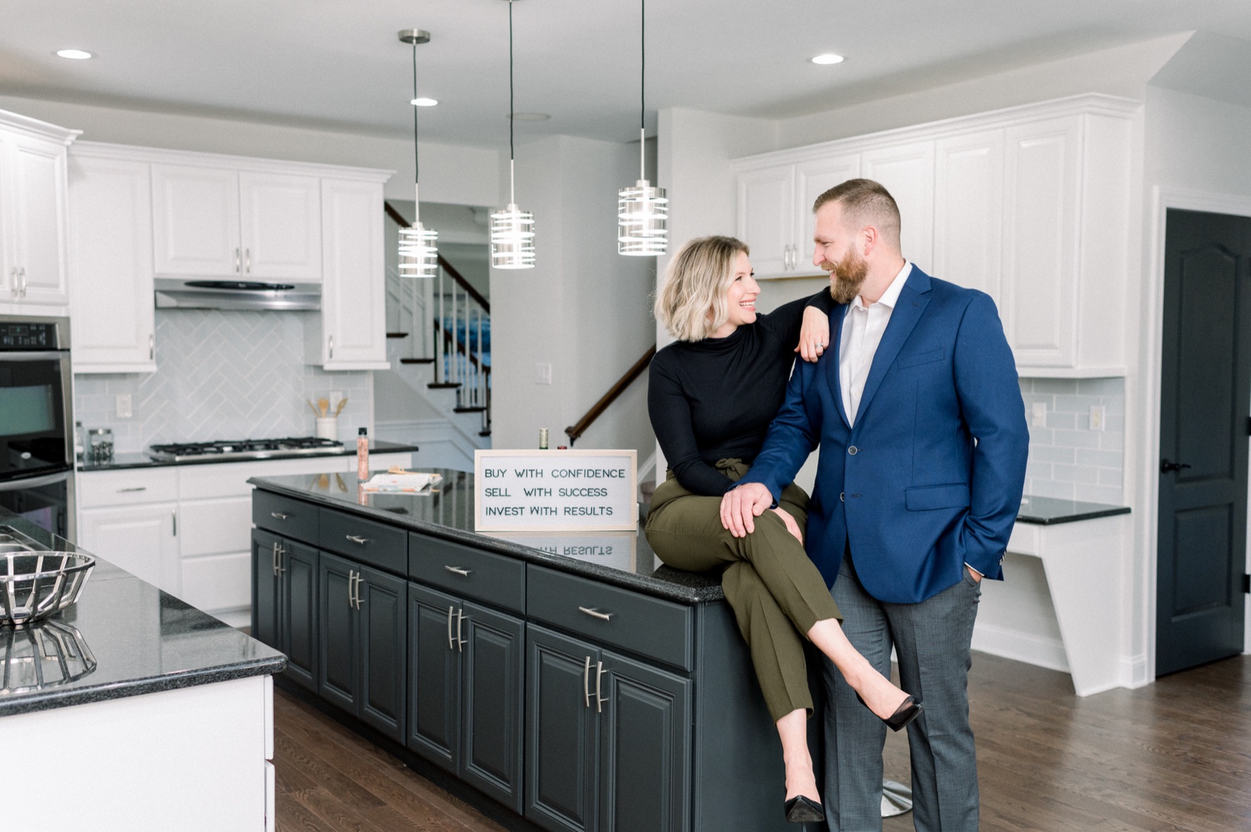 Ariella and Lukasz Boczniewicz with their brand taglines — Buy With Confidence · Sell With Success · Invest With Results